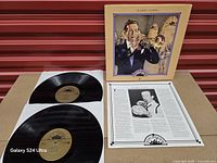 Gatefold opened showing both black vinyl discs, inner biography page and front cover