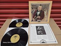 Open set showing both vinyl discs, insert, and jacket