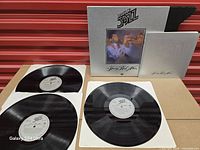 Slipcase, booklet, three LPs displayed