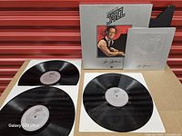 Box, booklet and three vinyl records laid out