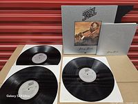 Three LPs, slipcase, booklet displayed