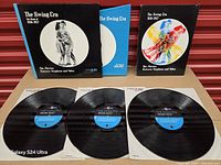 Records, album sleeve, and book displayed