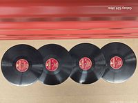 Four Columbia red-label shellac records laid out side by side