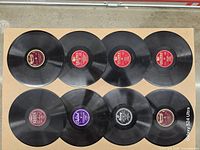 All eight 10-inch records laid out label side up showing label colours and condition