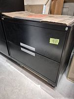 Front view of black two-drawer lateral file cabinet