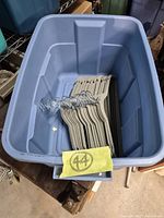 Blue tote containing stack of light gray velvet hangers