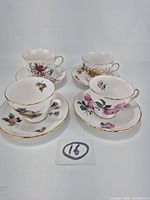 Four porcelain cup and saucer pairs displayed together