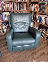 Front view of forest green leather recliner armchair showing seat, backrest and arms.
