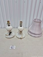 Pair of milk glass hobnail lamps with one pink shade