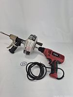Overall view of RIDGID drain auger attached to SKIL drill