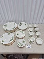 Full set showing plates, bowls, cups, creamer