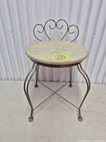 Front view of metal vanity stool showing seat and backrest