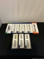 Group shot of all seven boxed pens