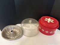 Group view: Bundt pan, acrylic cake plate with dome, red tin cake carrier