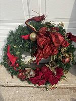 Front view of full wreath displaying greenery, bows, ornaments, and lights