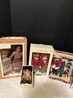 Group shot of all boxed dolls and stands