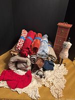 Group shot of all fabrics, doilies, pin cushion, and 4-drawer chest