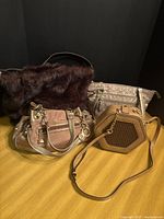 Group view of four handbags: Kathy Van Zeeland, Giani Bernini, hexagon crossbody, Bath & Body Works