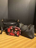 Group shot of all three handbags showing overall styles and sizes