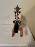 Front view of copper Cilio manual citrus press