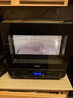 Front view of Whirlpool microwave showing door, control panel and digital display