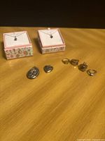 Full lot view showing necklaces in boxes, lockets, four rings
