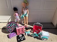 Group shot of all toys including dolls, cases, dish set, bicycle, washing machine