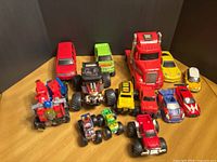 Group shot of all 13 toy vehicles and transformer