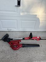 Both Craftsman trimmer and Toro blower on driveway