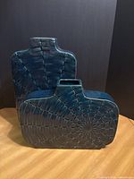 Both teal ceramic vases front view