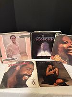 Front covers of five records including Al Jarreau, Motown single sleeve, unidentified female artist, Barry White, Anita Baker