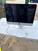 Front view of Apple iMac A1311 on table with power cord