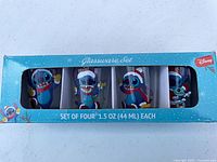 Front view of boxed set showing four Christmas Stitch shot glasses, capacity 1.5 oz each