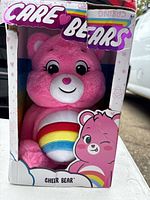 Front view of Cheer Bear plush inside Care Bears box