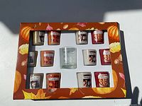Front of box showing 12 votive candles and glass holder