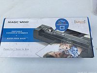 Front of retail box showing VuPoint Magic Wand portable handheld scanner and auto-feed dock