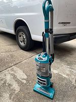 Full view of Shark upright vacuum standing on driveway