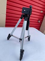 Full view of tripod standing on table with head and legs extended