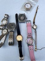 Overall view of nine wristwatches on table
