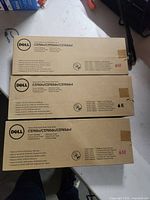Three Dell toner cartridge boxes showing model compatibility and yield markings