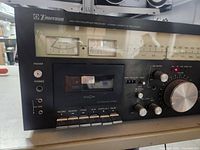 Front view showing dial, VU meters, cassette deck, controls