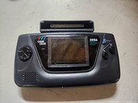 Front view of Sega Game Gear with Nuby Converter attached