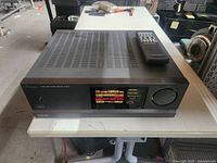 Front and top view of Mitsubishi receiver with remote placed on top