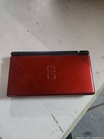 Closed red Nintendo DS Lite top view