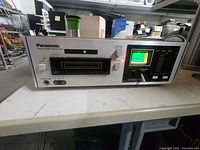 Front view showing controls, meter, program lights and cartridge slot