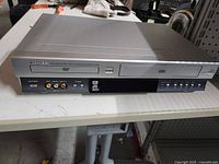 Front view showing Toshiba SD-V392U combo unit with VHS and DVD trays and front inputs