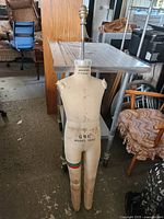 Front view of Wolf child dress form showing size marking and metal pole