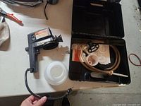 Sprayer gun, cord, plastic container, case with accessories
