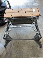Full view of folded-out Workmate workbench showing frame and wooden jaws