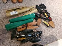 Pile of assorted boot and shoe shapers on carpet
